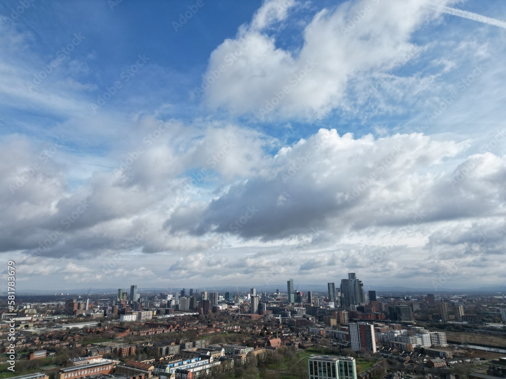 Aerial view of buildings and landmarks with views towards Manchester city centre. 