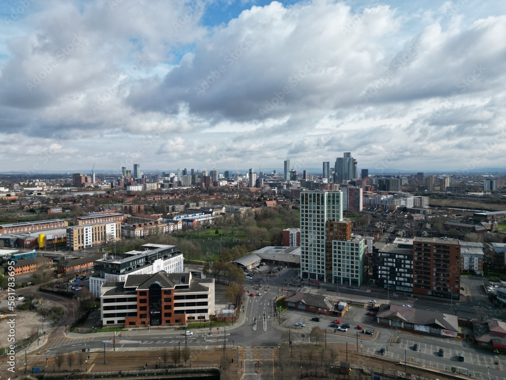 Aerial view of buildings and landmarks with views towards Manchester city centre. 