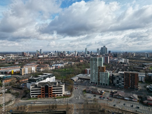 Aerial view of buildings and landmarks with views towards Manchester city centre. 