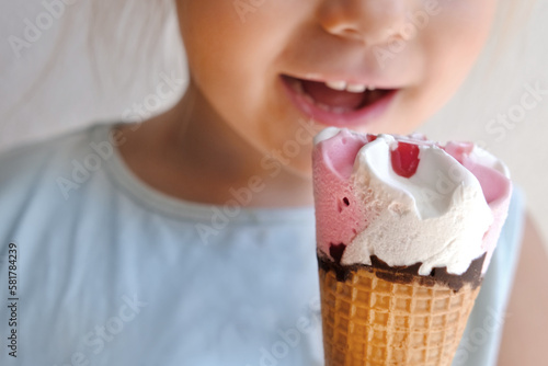 child 3 years old  going eat cold ice cream cone  strawberry dessert with fruit jam and chocolate  appetizing eating  happy childhood concept  children s delicacy  healthy and unhealthy food