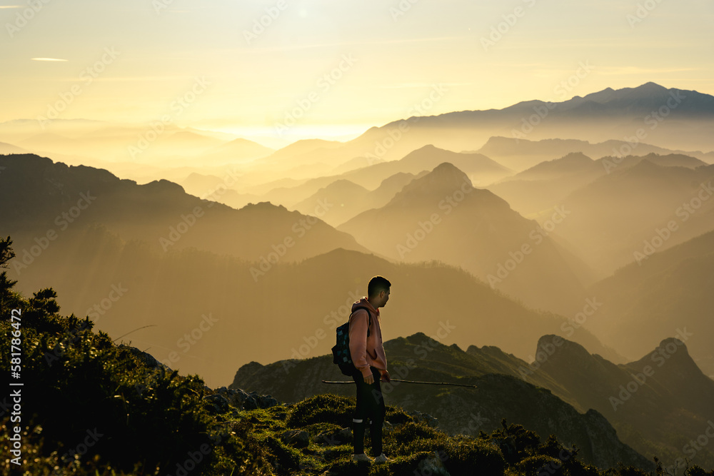 Hiker in the mountain during a gold sunset