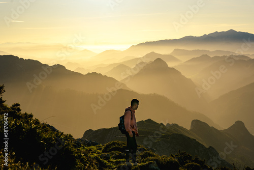 Hiker in the mountain during a gold sunset © lvaro