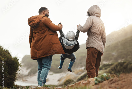 Nature fitness, holding hands and hiking family of mother, father and child walking, play and bond on mountain adventure. Love, freedom peace or back view of winter people trekking on outdoor journey