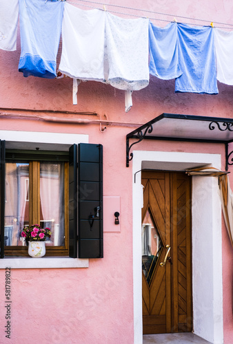 Washing Hanging Up Outside A Brightly Coloured Pink House In Burano  Venice
