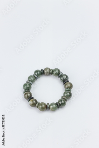 Bracelet made of natural green malachite on white background