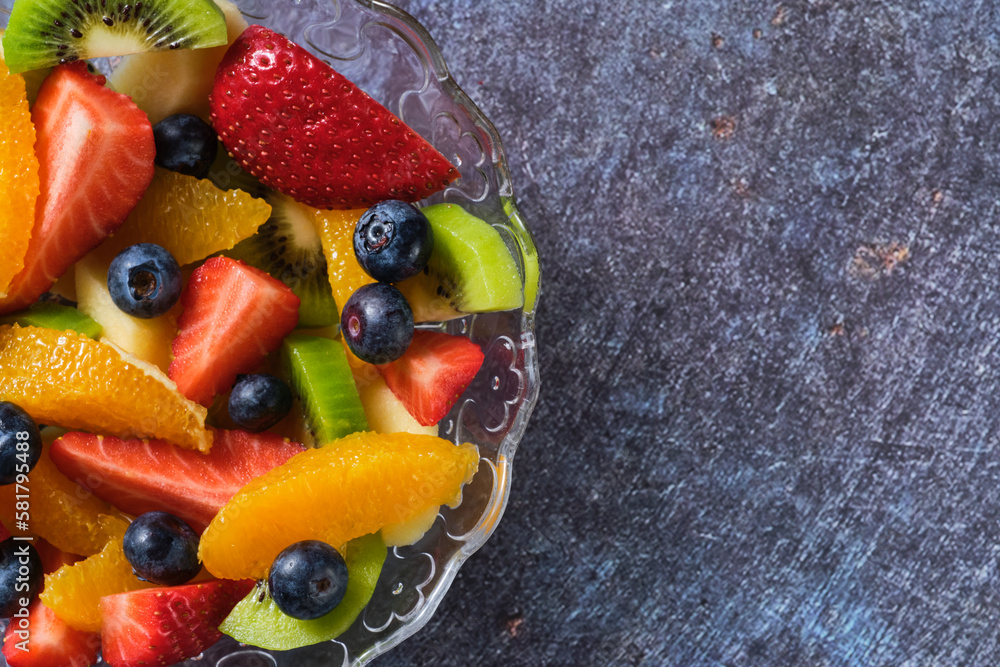 shot from above of a transparent bowl filled with pieces of healthy fresh fruit