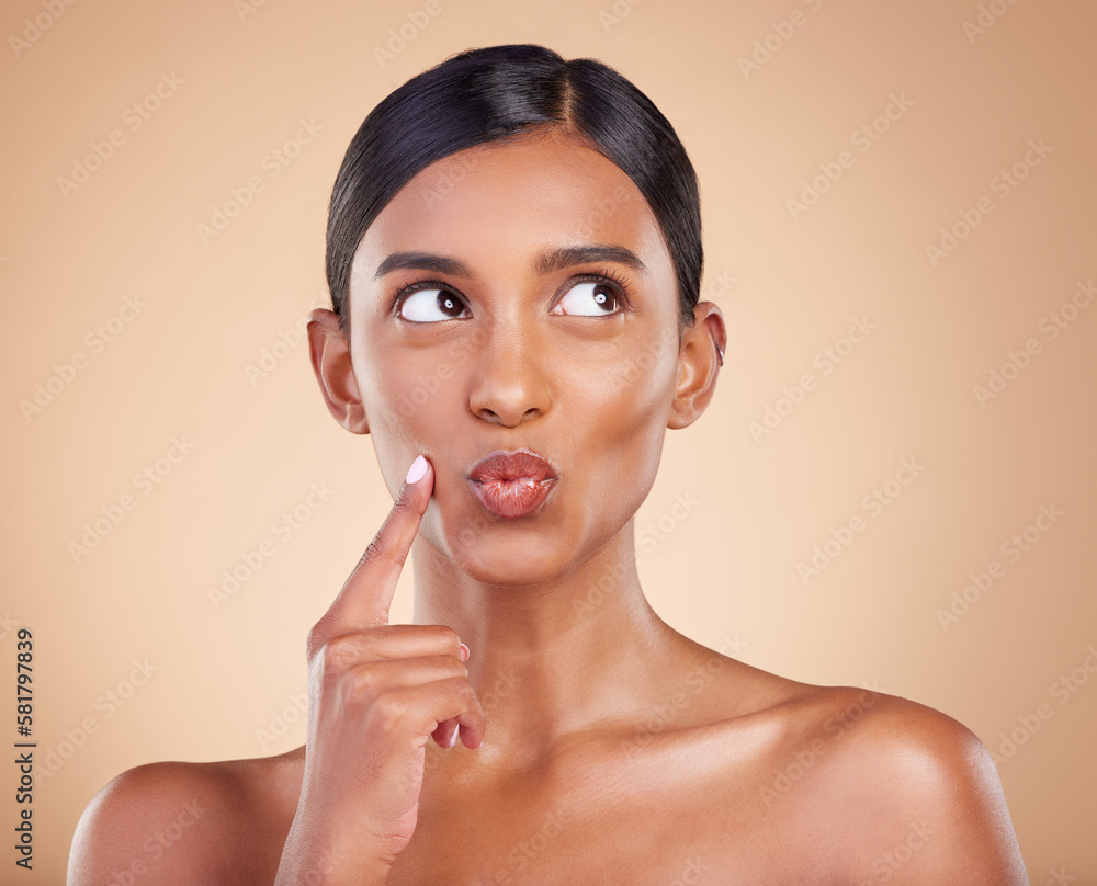 Indian woman, skincare and hand for thinking in studio with face, beauty and pouting by background. Young asian model, gen z girl and cosmetics for natural skin glow, aesthetic or happiness for idea