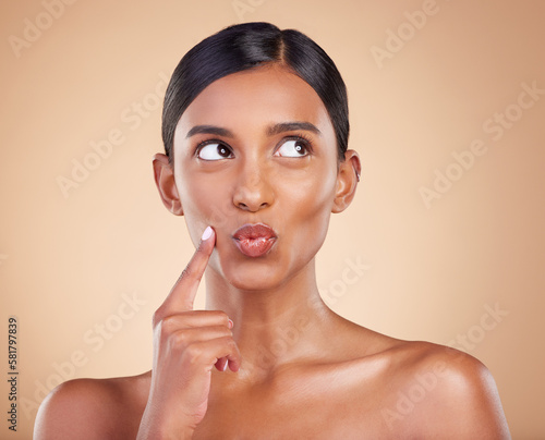 Canvas Print Indian woman, skincare and hand for thinking in studio with face, beauty and pouting by background