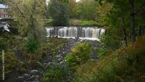 Waterfall with roaring and foaming water in Keila Joa park in autumn.