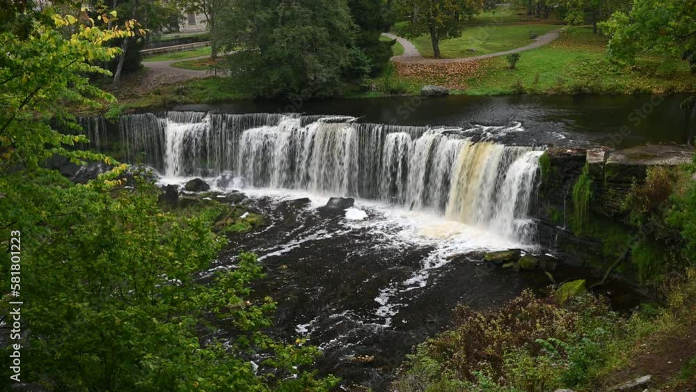 Waterfall with roaring and foaming water in Keila Joa park in autumn. Waterfall with roaring and foaming water in Keila Joa park in autumn.