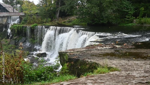 Waterfall with roaring and foaming water in Keila Joa park in autumn.