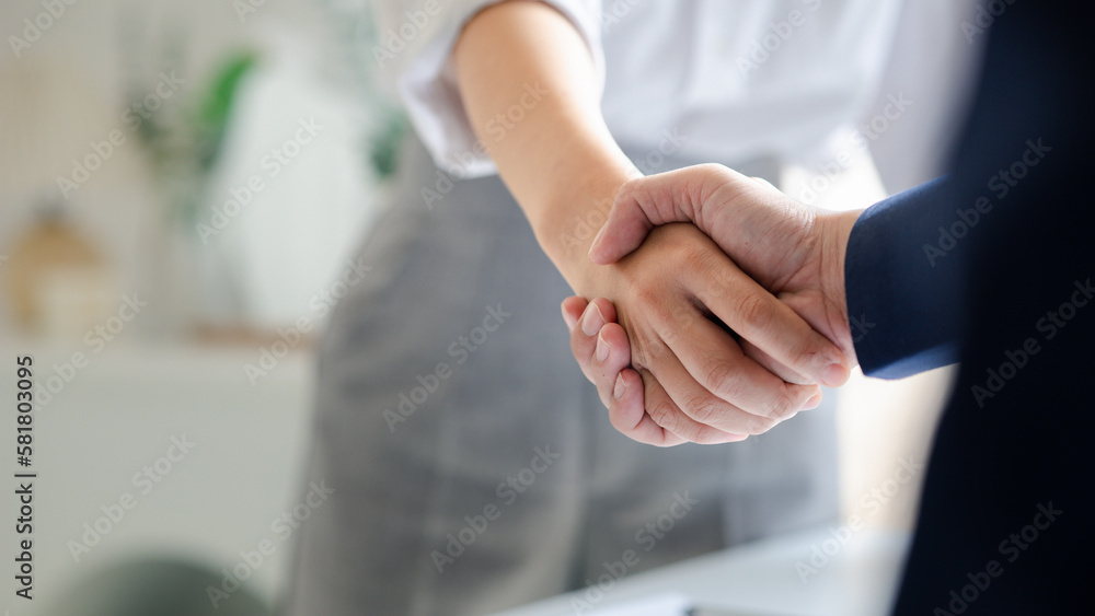 Business investor group holding hands, Two businessmen are agreeing on business together and shaking hands after a successful negotiation. Handshaking is a Western greeting or congratulation. Business investor group holding hands, Two businessmen are agreeing on business together and shaking hands after a successful negotiation. Handshaking is a Western greeting or congratulation.