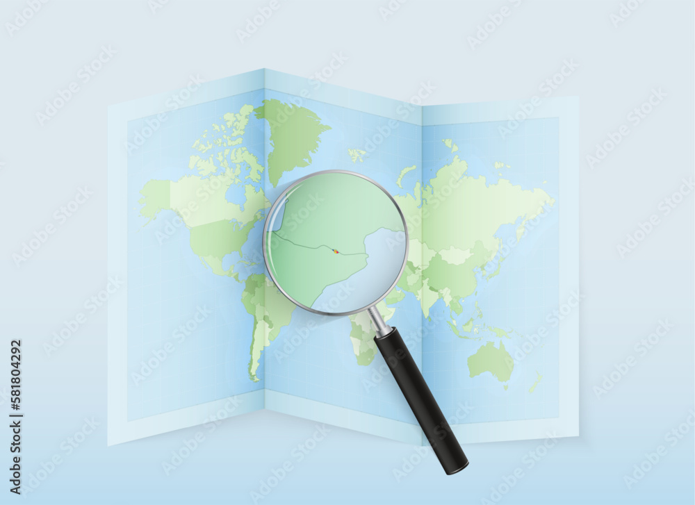 Poster A folded world map with a magnifying lens pointing towards ...