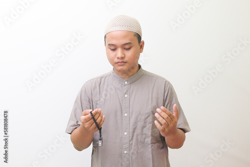 Portraits of asian muslims praying with Islamic beads. isolated images on a white background