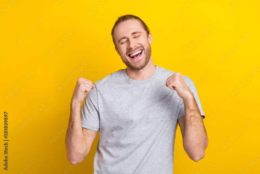 Photo of glad candid man wear stylish clothes rejoice win jackpot dream go shopping sale discount isolated on yellow color background Photo of glad candid man wear stylish clothes rejoice win jackpot dream go shopping sale discount isolated on yellow color background