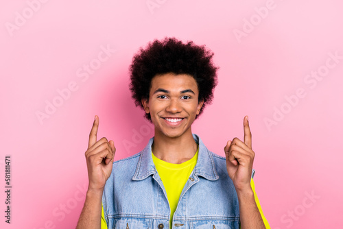 Photo of cheerful nice person beaming smile indicate fingers up above empty space isolated on pink color background