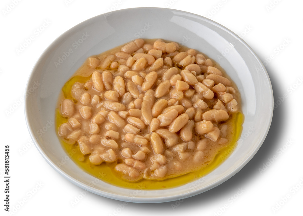 Bean soup seasoned with extra virgin olive oil in a white dish on rustic wooden boards