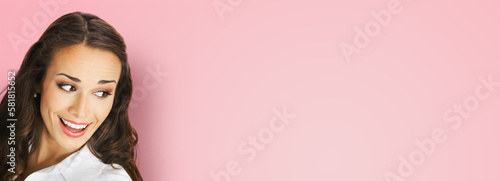 Happy excted smiling woman in white confident cloth looking aside. Business advertisement concept. Brunette businesswoman, isolated rose pink background. photo