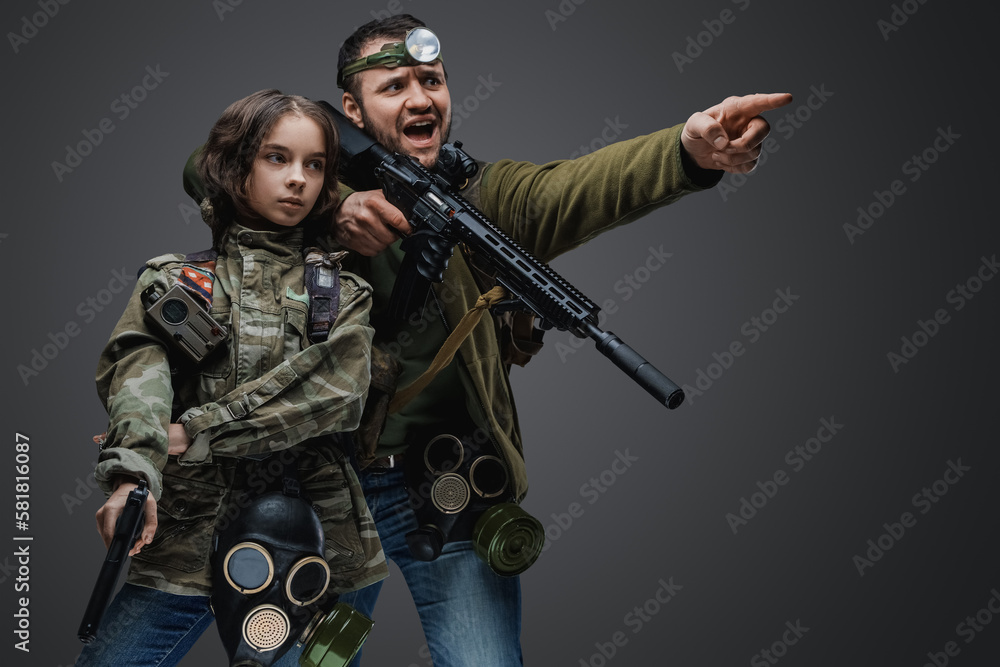 Fototapeta premium Studio shot of post apocalyptic girl teenager and man surviving after armageddon.