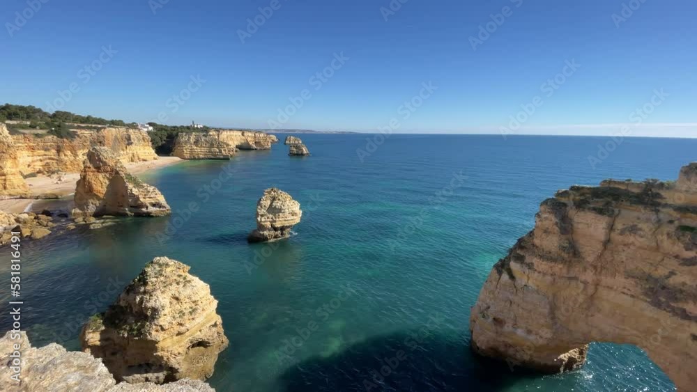 Beautiful cliffs and rock formations by the Atlantic Ocean at Marinha Beach in Algarve, Portugal Beautiful cliffs and rock formations by the Atlantic Ocean at Marinha Beach in Algarve, Portugal