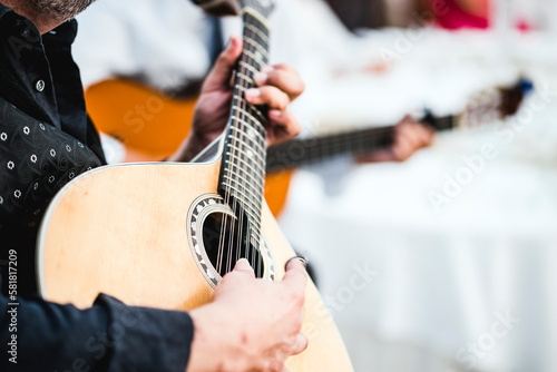 Close up of the guitar of a man playing traditional Portuguese fado