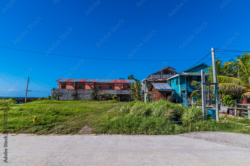 A view of a typical settlement on the shoreline of Roatan Island on a sunny day A view of a typical settlement on the shoreline of Roatan Island on a sunny day