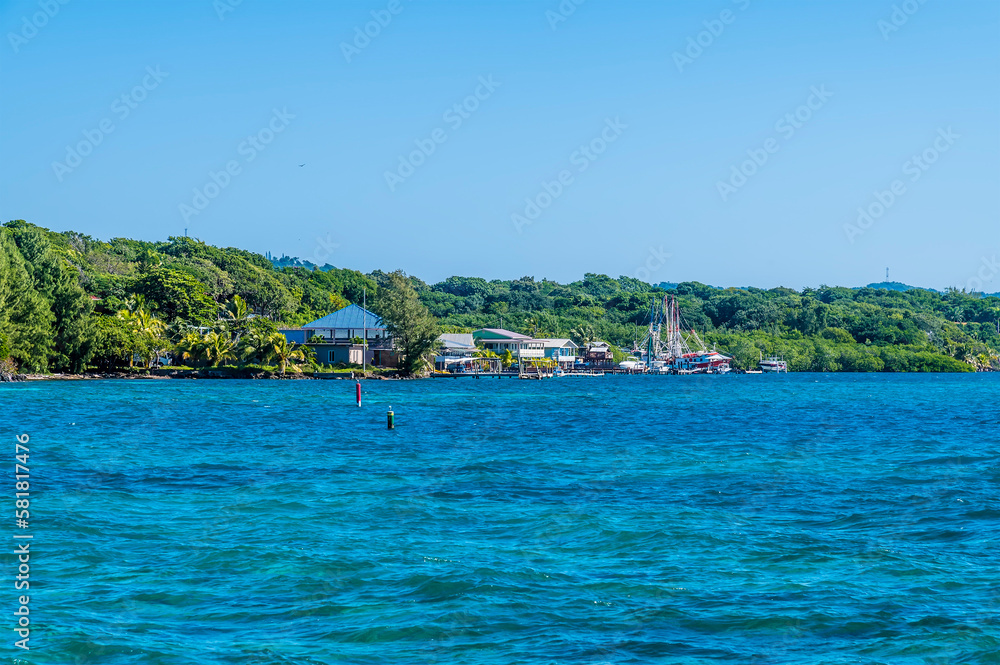 A view towards a village on Roatan Island on a sunny day A view towards a village on Roatan Island on a sunny day