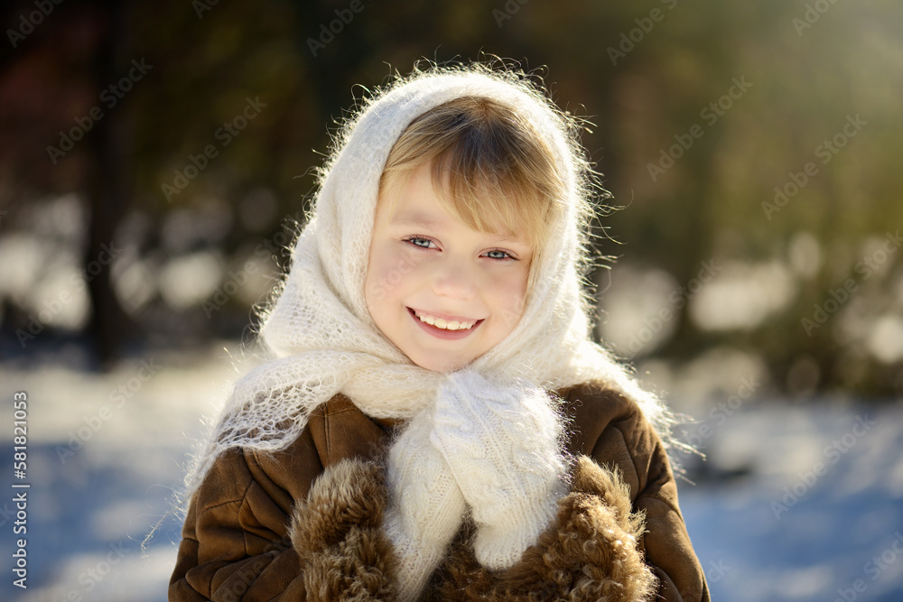 Portrait of a very cute and pretty girl with blue eyes and golden hair, smiling beautifully, dressed in a white wool scarf and mittens. Beautiful blonde girl smiling sweetly Portrait of a very cute and pretty girl with blue eyes and golden hair, smiling beautifully, dressed in a white wool scarf and mittens. Beautiful blonde girl smiling sweetly