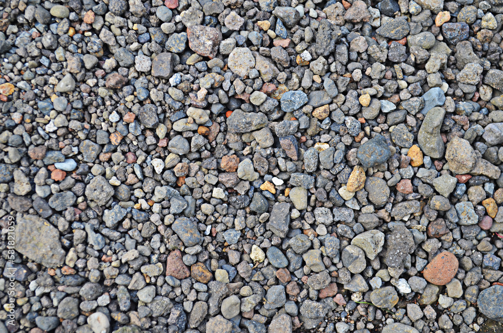 pile of mixed colored fine and coarse pebbles. rock background. stone wall texture pile of mixed colored fine and coarse pebbles. rock background. stone wall texture