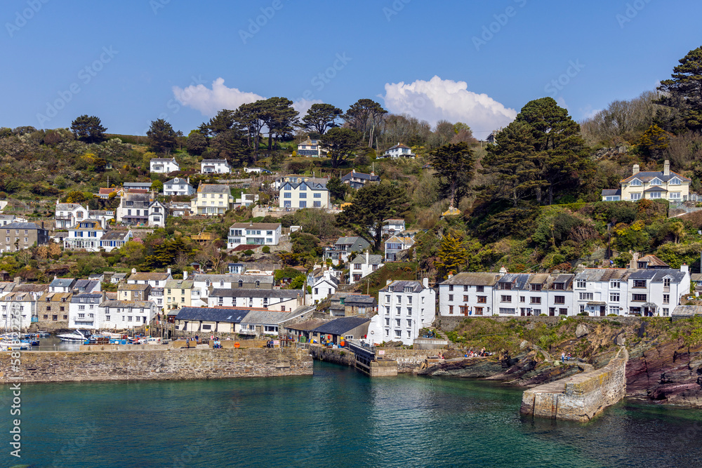 The fishing village of Polperro, with its harbour wall and narrow entrance to the inner harbour. Polperro is a charming and picturesque fishing village in south east Cornwall.	