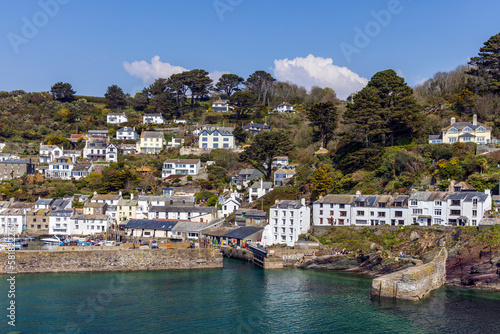 The fishing village of Polperro, with its harbour wall and narrow entrance to the inner harbour. Polperro is a charming and picturesque fishing village in south east Cornwall.	 photo