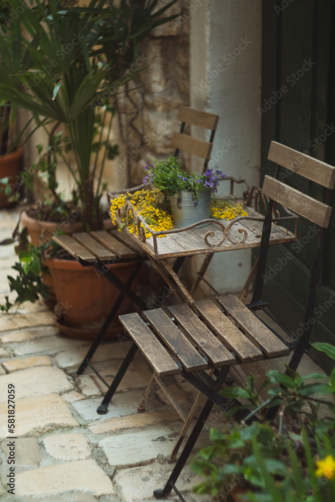 Old wooden chairs in cozy patio garden on the narrow street of ROvinj Croatia Istria