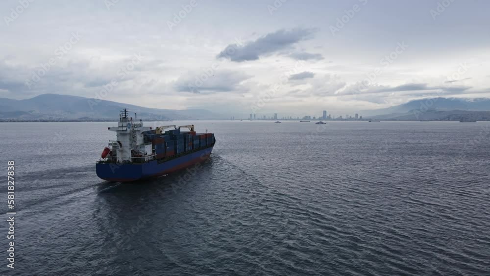 Aerial drone video of container ship with truck size containers cruising in Mediterranean Aegean sea. Global extort trade Aerial drone video of container ship with truck size containers cruising in Mediterranean Aegean sea. Global extort trade