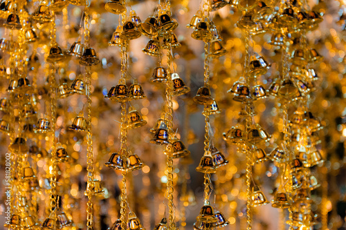 Blurry image with  selected focus of little Bells for good fortune, in a Temple at the Wat Arun Temple complex in Bangkok, Thailand.