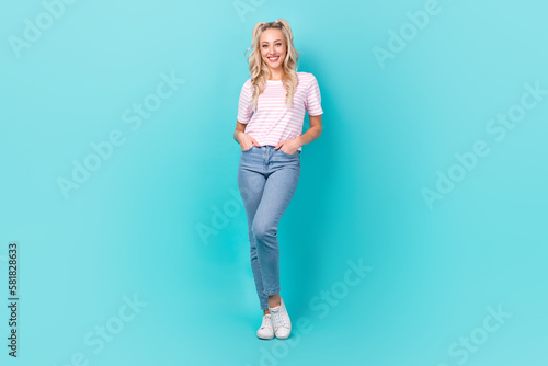 Full body portrait of positive lovely lady put hands pockets posing isolated on teal color background