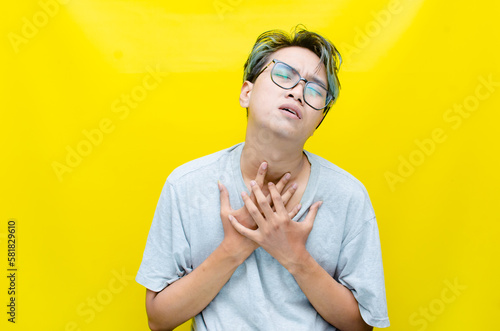 portrait of An Asian man has a stressed, glum, and messed-up appearance. a man who is angry and agitated. freaked out over work. photo