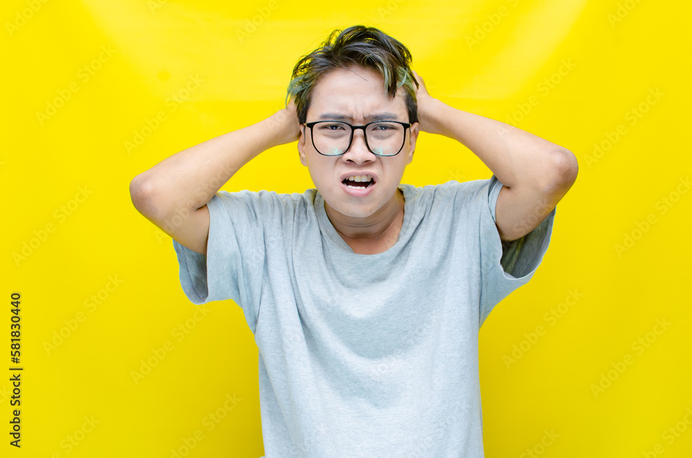 portrait of An Asian man has a stressed, glum, and messed-up appearance. a man who is angry and agitated. freaked out over work. portrait of An Asian man has a stressed, glum, and messed-up appearance. a man who is angry and agitated. freaked out over work.