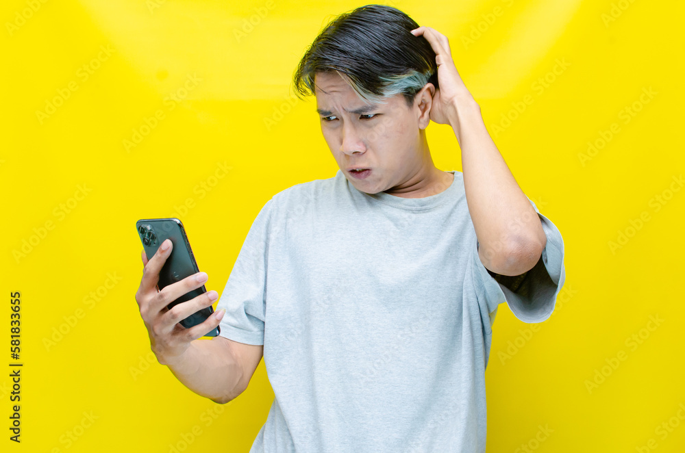 Irritated, depressed, and messed asian young man shouting to phone madly and angrily. Irritated, depressed, and messed asian young man shouting to phone madly and angrily.