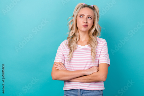 Portrait photo of intelligent distrust youngster lady crossed hands looking pouted lips empty space bad idea isolated on aquamarine color background