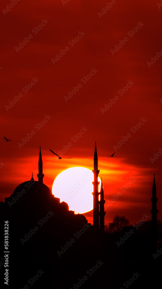 Suleymaniye Mosque and sun at sunset. Islamic or ramadan vertical photo.