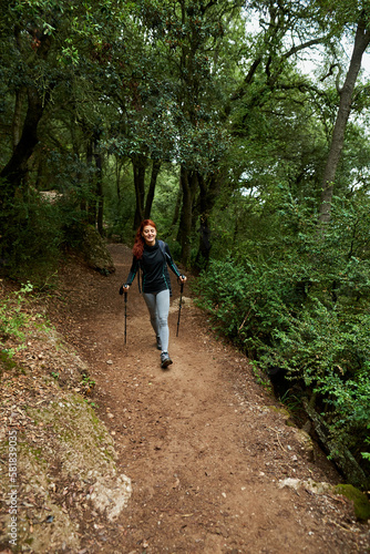 Female traveler hiking amidst trees