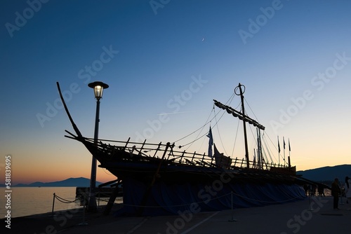 the silhouette of the mythical ship Argo on the beach of Volos at sunset, Greece photo