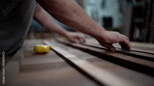 Carpenters hands and timber