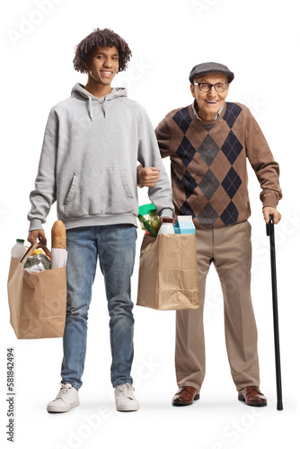 Young african american man helping anold man with grocery bags