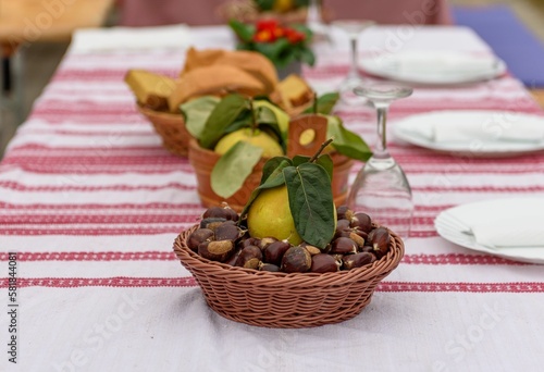 Selective focus of quince on top of a chestnut basket on a party table