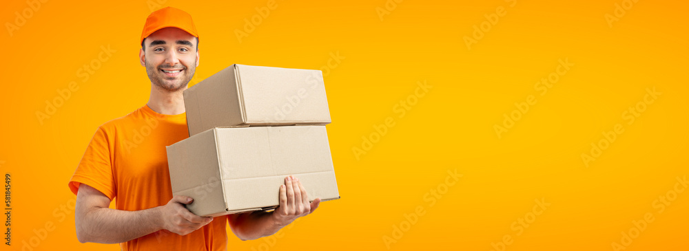Delivery man with a box. Courier in uniform cap and t-shirt service fast delivering orders. Young guy holding a cardboard package. Character on isolated white background for mockup design Delivery man with a box. Courier in uniform cap and t-shirt service fast delivering orders. Young guy holding a cardboard package. Character on isolated white background for mockup design