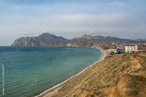 View of seaside resort city Koktebel , mountain Kara Dag from hill in spring. Crimea photo