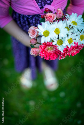 Young asian girl holding bouquet of flowers in spring