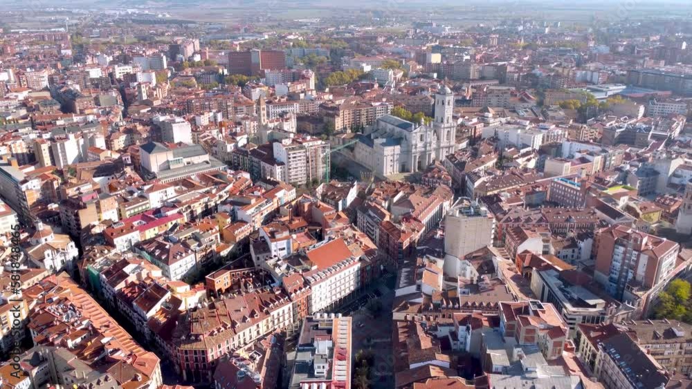 Rooftops of Valladolid city. Aerial drone perspective of city center. Drone backward starting from the Cathedral of Valladolid and tilt down camera on the main square Plaza Mayor. Sunrise colours Rooftops of Valladolid city. Aerial drone perspective of city center. Drone backward starting from the Cathedral of Valladolid and tilt down camera on the main square Plaza Mayor. Sunrise colours