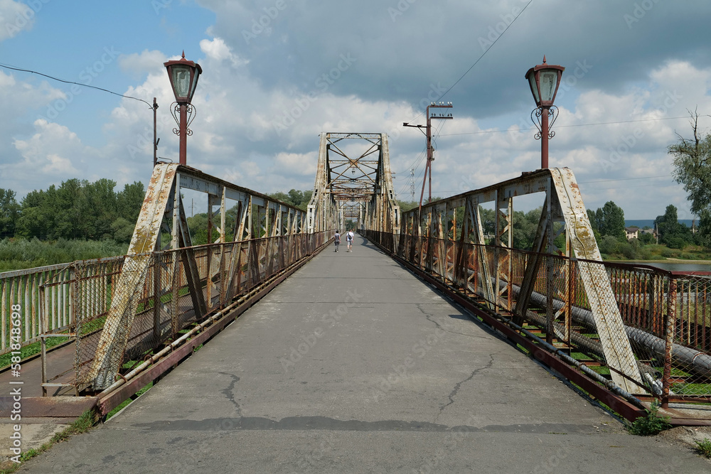 Fototapeta premium Old metal bridge across Dniester river in the city of Halych, western Ukraine